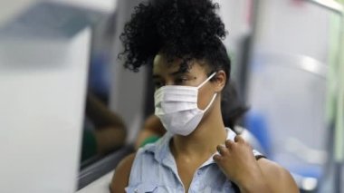Commuter woman in metro subway wearing virus prevention mask
