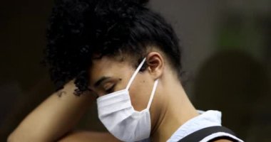 Commuter black girl in underground subway. Young millennial woman wearing covid pandemic mask