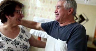 Older man hugging wife, married senior couple embrace