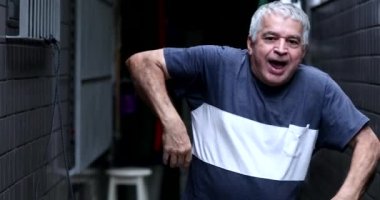 Old man celebrating success dancing funny funky dance
