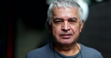 Older man portrait looking at camera, natural and casual senior