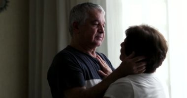 Senior husband caring for wife, loving maried couple relationship
