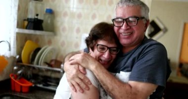 Married senior couple hugging and kissing each other. Older couple showing love and affection