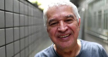 Older man portrait looking at camera, middle aged person staring camera