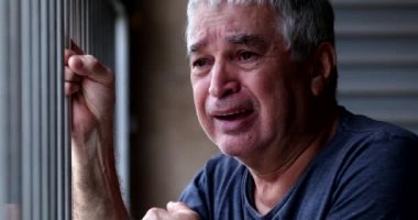 Older man crying with grief and pain. Senior person suffering alone