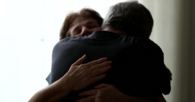 Married senior couple hug. Candid older husband and wife embrace