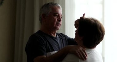 Older couple embrace, senior emocional intimacy. middle aged husband hugging and caring for wife