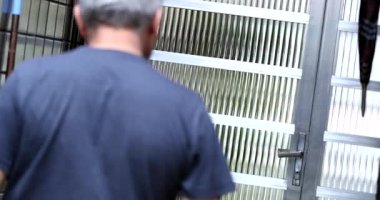 Casual man opening home door exiting