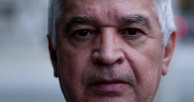 Older middle-aged man portrait close-up face, wrinkled unshaven
