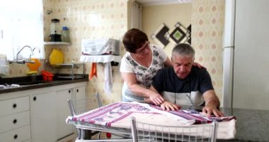 Senior couple suffering. Older wife consoling older husband through difficulties