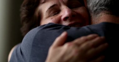 Empathic hug and support close-up senior woman embracing person
