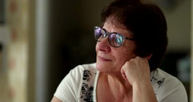 Pensive older woman daydreaming. Thoughtful senior lady thinking