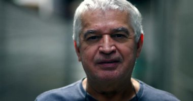 Portrait middle-age man looking at camera. Older 60 year old person, casual natural