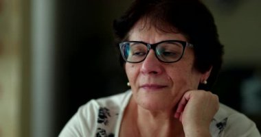 Senior woman turning head to window