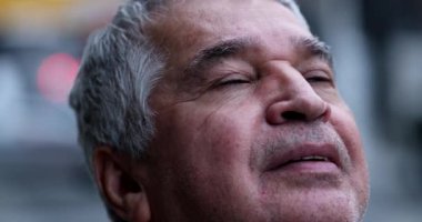 Umut dolu yaşlı adam FAITH ile gökyüzüne bakıyor.