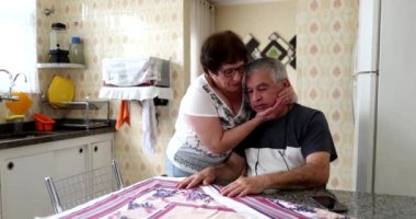 Older wife supporting senior husband through difficulties