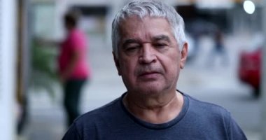 Pensive senior portrait outside. Serious older middle-aged man