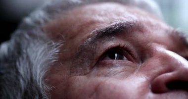 Spiritual older man closing eyes in contemplation, person feeling the presence of God