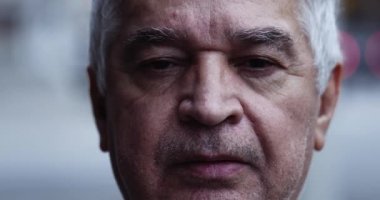 Serious older man portrait looking at camera