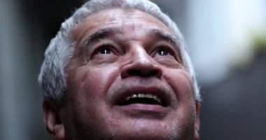 Senior man feeling the presence of God, older person looking at sky with faith