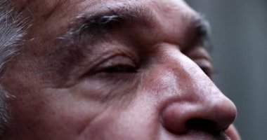 Senior man eyes lifting head to sky with hope and faith