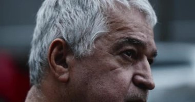 Depressed older man seeking hope looking up to sky. Hopeful middle-aged man in crisis