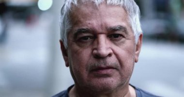 Older man staring to camera, Portrait senior unshaven person