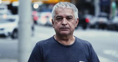 Portrait serious old man looking at camera unshaven and tired