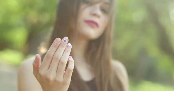 Attractive young woman inviting with finger and hand. Millennial girl invites beckhoning viewer
