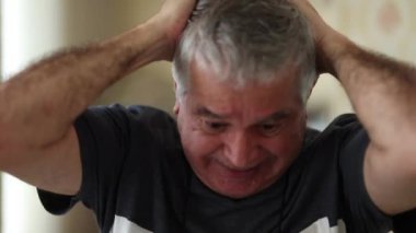 Happy middle aged man cheering triumphant. Senipr feeling victorious