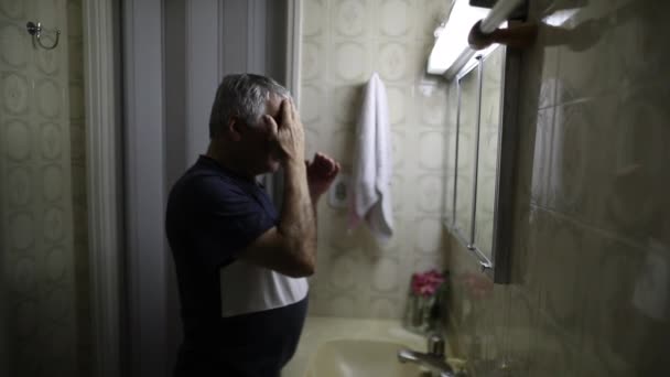 Older Man Standing Bathroom Mirror Staring Mirror Depressed Troubled Middle — Stock video