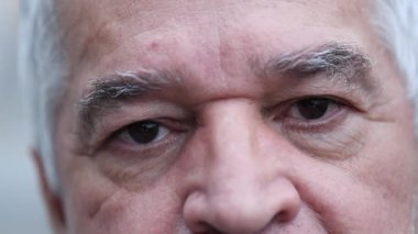 Middle aged senior man close-up face staring at camera