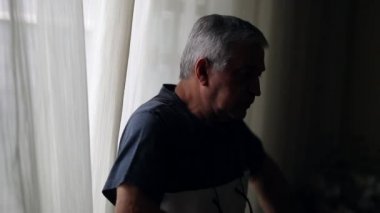 Lonely older man in shadow penumbra