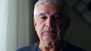 Unshaved Serious Senior man looking at camera