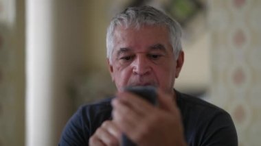 Older man using cellphone device