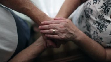 Close-up hands joined together in care