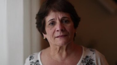 Senior woman portrait smiling at camera indoors