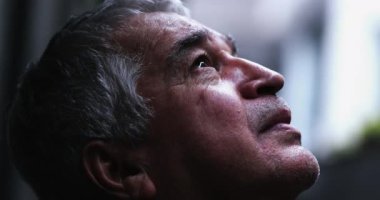 Worried depressed senior looking to sky