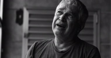 Dramatic senior man crying in despair, black and white