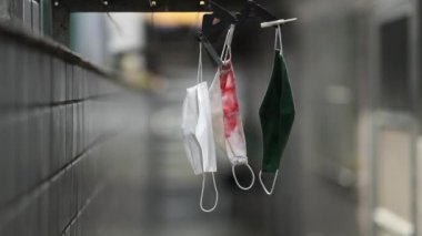 Drying mask hanging after use for disinfecting. Face masks hanging on rack outside