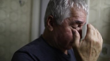 Senior man doing Catholic cross sign