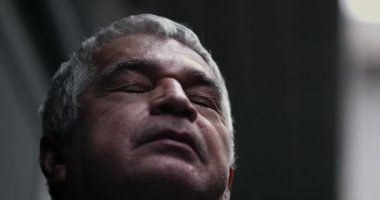 Older man opening eyes looking at sky with HOPE and FAITH