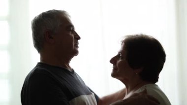 Older couple hugging each other in support