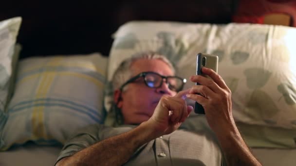Μεγαλύτερος Άντρας Που Βλέπει Οθόνη Κινητού Βράδυ Στο Κρεβάτι — Αρχείο Βίντεο