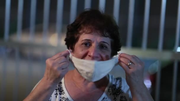 Senior Woman Putting Covid Face Mask Night City — Stockvideo
