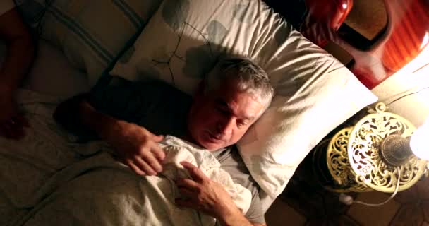 Older Man Laying Bed Turning Night Lamp — Video Stock