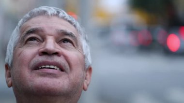 Senior person in contemplation looking at sky with hope and faith