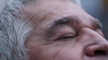 Senior man closing eyes in contemplation