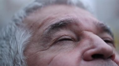Elder man close-up eyes looking up