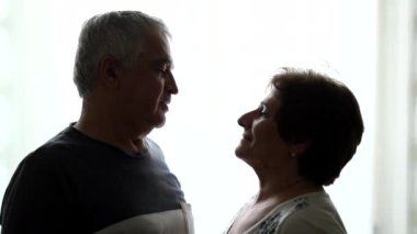Senior couple staring at each other. Older husband and wife profiles